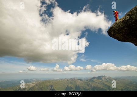 BASE jump from a cliff. The ultimate kick to do an object jump with a wingsuit on. Man get ready to fly along the mountains. Stock Photo