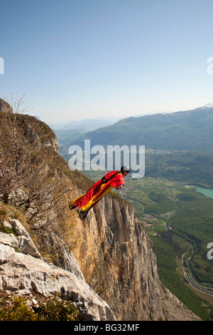 BASE jump from a cliff. The ultimate kick to do an object jump with a wingsuit on and fly proximity along the mountain. Stock Photo