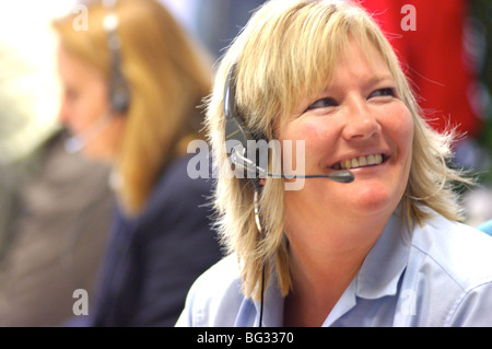 Royalty free photograph of customer support operator helping client on telephone in UK London offices. Stock Photo