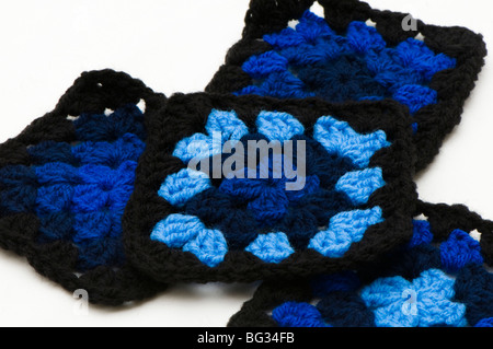 Hand crocheted black and blue multi-coloured granny squares made out of acrylic double knitting wool Stock Photo