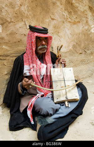 Bedouin man playing stringed instrument, Beida (Al Baidha) (Little Petra), Jordan, Middle East Stock Photo