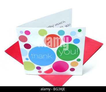 An opened thank you card stands on a red envelope. Stock Photo