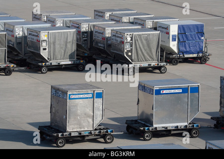 Commercial air freight transport logistics. Air cargo containers on the ramp or apron at an airport waiting for loading. Supply chain. Free market. Stock Photo