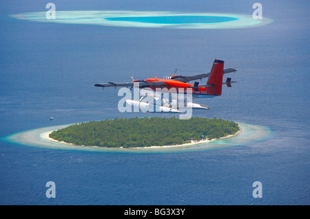 Maldivian Air Taxi flying above island, Maldives, Indian Ocean, Asia Stock Photo