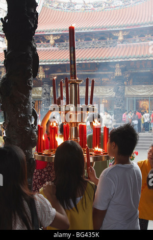 People lighting incense sticks, Longshan Temple, Taipei, Taiwan, Asia Stock Photo