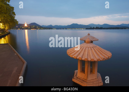 Xi Hu (West Lake) at dusk with Jinci Si Pagoda in background, Hangzhou, Zhejiang, China, Asia Stock Photo