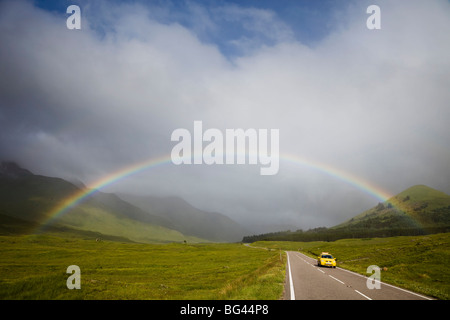 Scotland, Highland Region, Empty Road and Rainbow Stock Photo