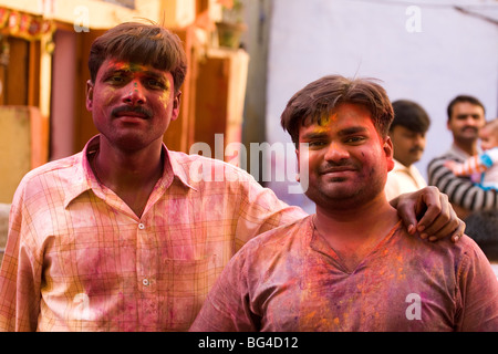 Indian men enjoy Holi in the Paharganj area of Delhi. Holi is often called 'The Festival of Colour'. Stock Photo