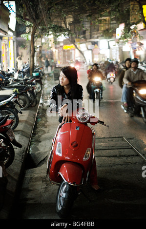 Girl sitting on red Vespa, Hanoi, Vietnam, Indochina, Southeast Asia, Asia Stock Photo