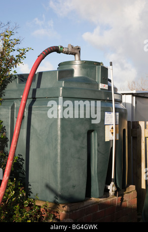 Britain, UK, Europe. Filling a domestic oil tank with supply pipe and nozzle in the top Stock Photo