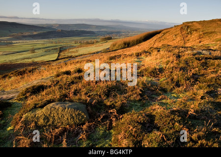 Morning sunshine on Embsay Moor, North Yorkshire, with a view in the distance of Pendle Hill Stock Photo