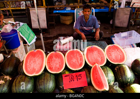 Tasty watermelons for sale in the fresh produce market in Chiang Rai. Stock Photo