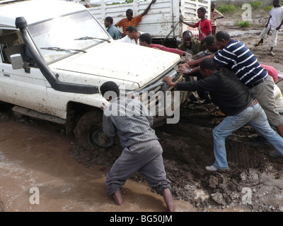 The roads are bad in Ethiopia and all the cars get stuck in the mud. Stock Photo