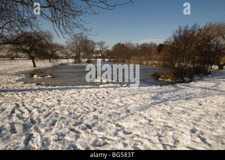 pond covered in ice and snow in Blackheath Stock Photo