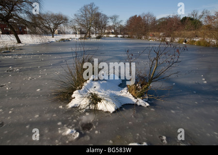 pond covered in ice and snow in Blackheath Stock Photo