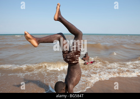 Youths exercise on the shores of Lake Malawi near the town of Karonga, Malawi in Southern Africa. Stock Photo