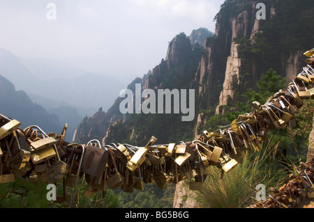 Lovers padlocks fastened to the chains along the tracks of Huang Shan mountains. Anhui province. China Stock Photo