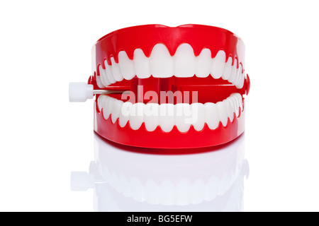 A pair of joke wind up chattering teeth on a pure white background, high resolution photo. Stock Photo