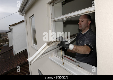 Removing old window frame before Installing new double glazed windows in a house Stock Photo