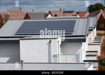 Roof-mounted photo voltaic solar panels on a new housing estate Stock Photo