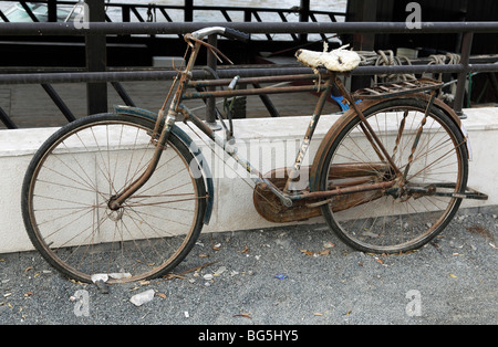 A rusty bicycle leaned on a balustrade, Dubai, United Arab Emirates A rusty bicycle leaned on a balustrade, Dubai, United Arab Emirates