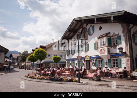 Alpine Hotel and pavement cafe in Bavarian town of Oberammergau Bavaria Germany Europe. Stock Photo