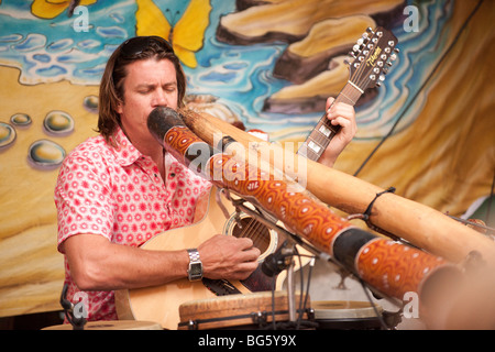 A street performer plays a guitar and pipes during Ottawa's annual International Busker Festival August 2nd 2009. Stock Photo