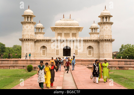 Women in the gardens of Itmad-Ud-Daulah's Tomb in  Agra, India. The tomb is often termed 'the baby Taj'. Stock Photo