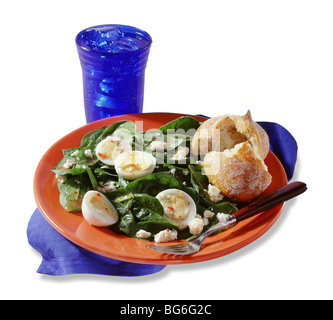 Spinach and hard boiled egg salad with roll on white Stock Photo