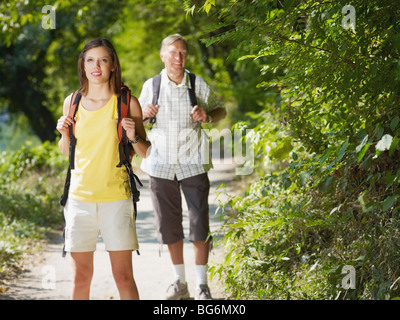 senior and young hikers in wood. Copy space Stock Photo
