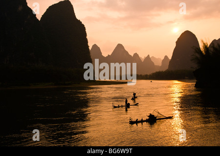Cormorant fishermen on Li River at sunset, Guangxi, China Stock Photo
