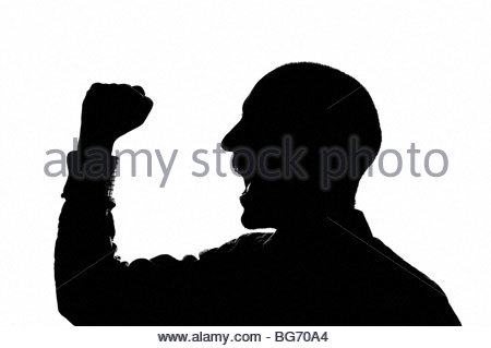 Silhouetted man cheering Stock Photo