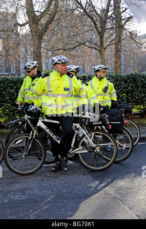 Metropolitan police officers on bikes at climate change march London England UK
