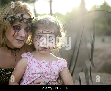 Witch woman dress for halloween with dark wings and a make-up girl Stock Photo