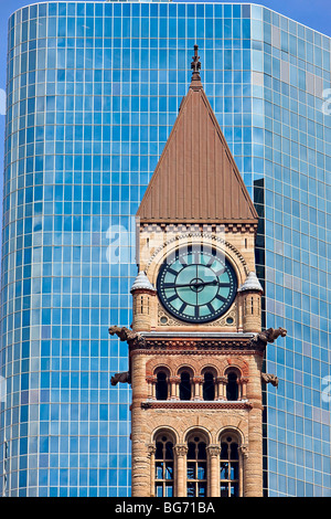Clock tower of the old city hall surrounded by modern buildings in downtown Toronto, Ontario, Canada. Stock Photo