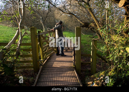 Occombe Farm is an organic farm in Paignton,South Devon,a young father pushes a pushchair around a 2km easy-access nature trail Stock Photo