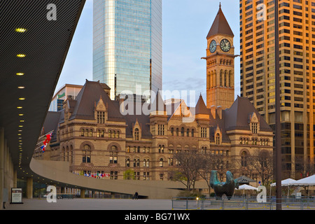 Old City Hall building seen from outside the New City Hall in the Nathan Phillips Square at sunset in downtown Toronto, Ontario Stock Photo