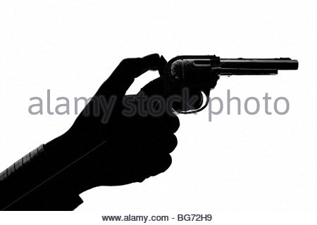 Silhouetted man pointing toy gun Stock Photo