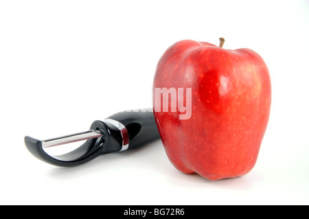 Apple and peeler Stock Photo