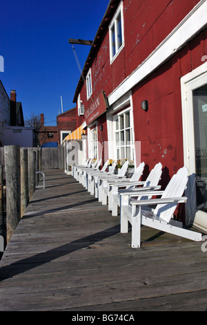 Adirondack waiting chairs outside the Scrimshaw Restaurant, Greenport, Long Island, NY Stock Photo