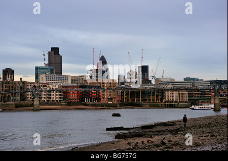 LONDON, UK - NOVEMBER 28, 2009:  Lowtide on the River Thames with City of London skyline in the background Stock Photo