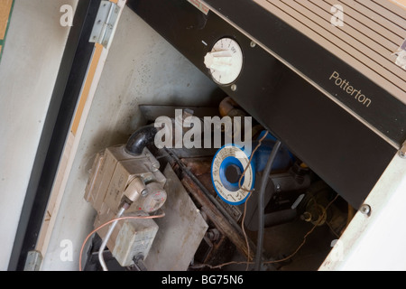 Old, inefficient, domestic gas central heating boiler, London UK Stock Photo