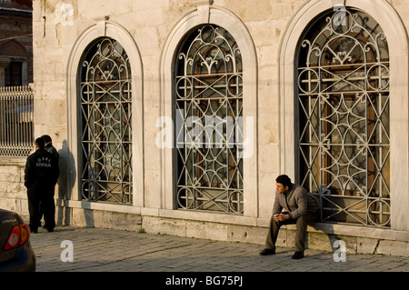 Man sat on a ledge by the Aya Sofiya, Istanbul, Turkey Stock Photo