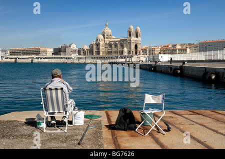Fisherman in Front of Marseille Cathedral or Cathédrale de la Major, La Joliette,  Marseille Docks, Marseille, Provence, France Stock Photo