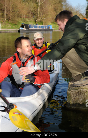 Major Dave Bradley (centre) and Steve Vinall receive drinks from Sergeant Shane Willoughby at the starting point for The Devizes Stock Photo