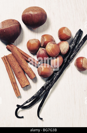 Vanilla beans cinnamon sticks and chocolate on wooden background Stock Photo