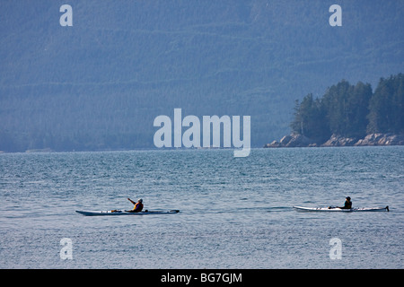 Visitors paddle kayaks in the Broken Group Islands of Pacific Rim National Park on the west coast of Vancouver Island, Canada. Stock Photo