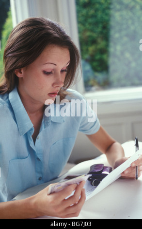 young woman with credit cards looking worried Stock Photo