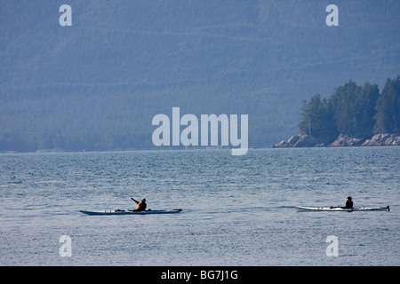 Visitors paddle kayaks in the Broken Group Islands of Pacific Rim National Park on the west coast of Vancouver Island, Canada. Stock Photo