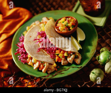 Fish tacos with purple cabbage and salsa on green plate Stock Photo